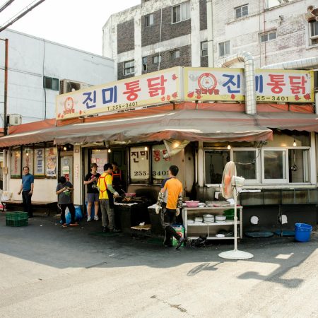 people relaxing by small restaurant in korea
